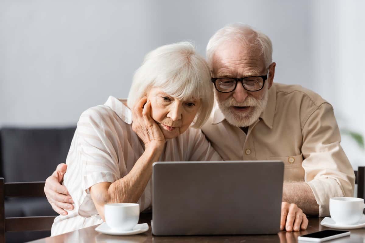 Older couple with laptop doing taxes