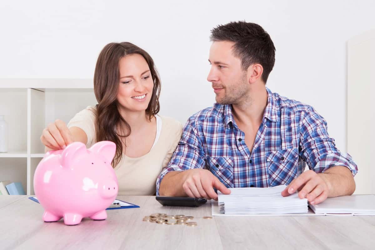 Couple saving money with piggybank 