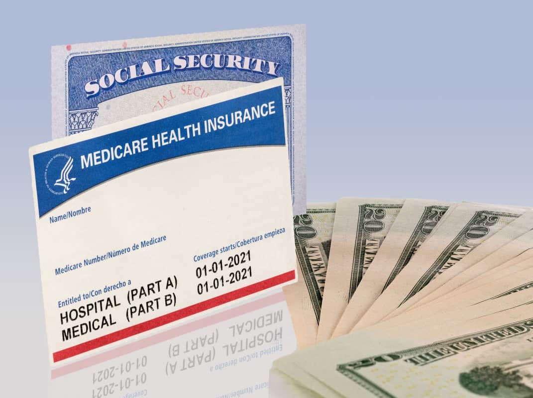 USA social security card and a Medicare health insurance card with 20 dollar paper currency to show funding crisis