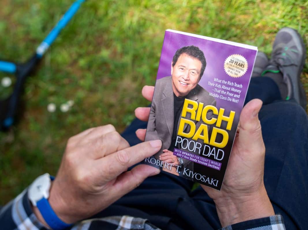 Someone reading the iconic book Rich dad and Poor Dad