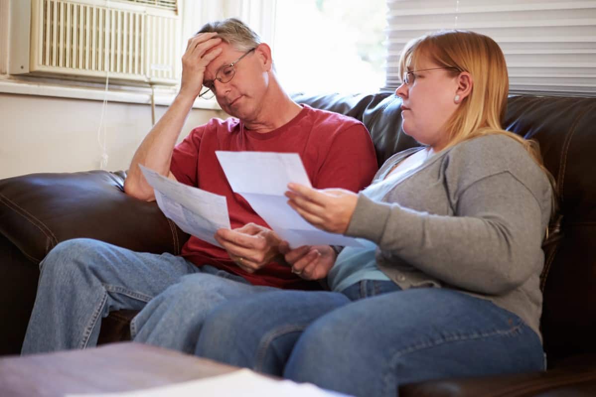 Worried Couple Looking At Bills 