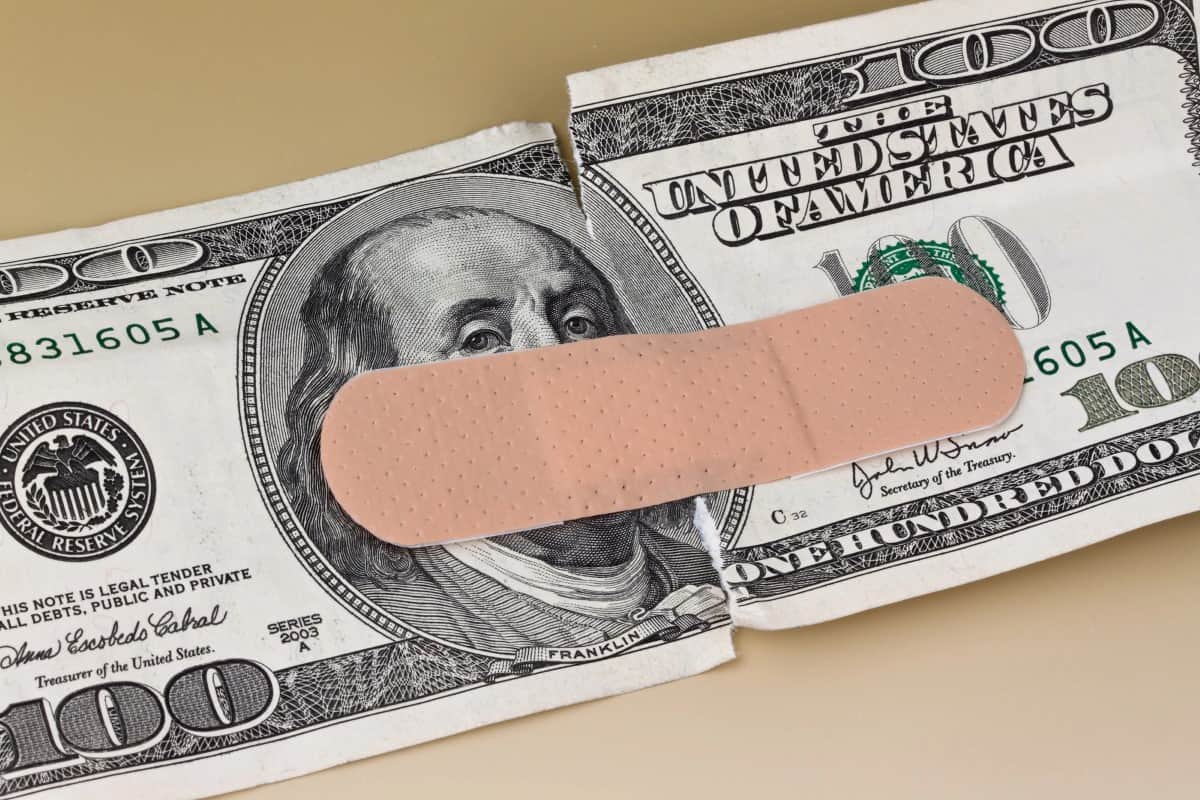 U.S. dollars banknotes with a band-aid Spending by borrowing