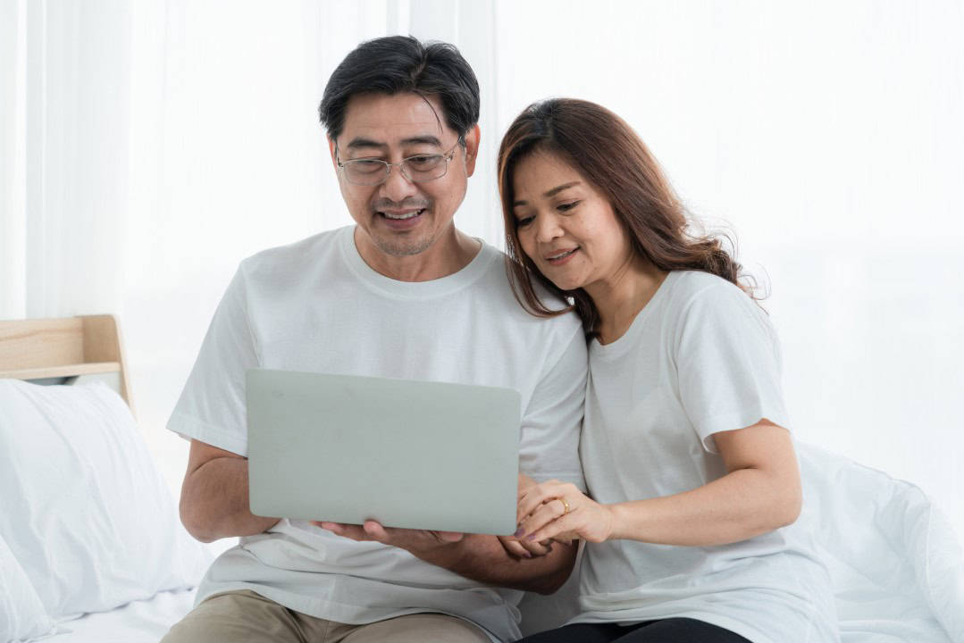 Happy Asian senior couple having good time at home. Old people retirement and healthy citizens elderly concept.