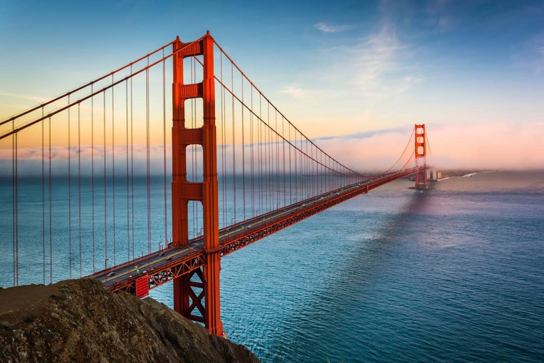 Sunset view of the Golden Gate Bridge and fog from Battery Spencer, Golden Gate National Recreation Area, in San Francisco, California.