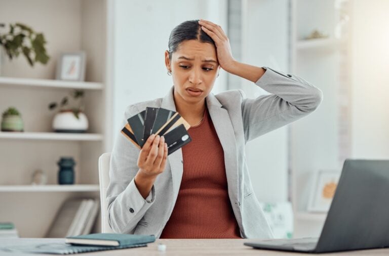 Financial stress, concerned and frustrated woman holding credit cards