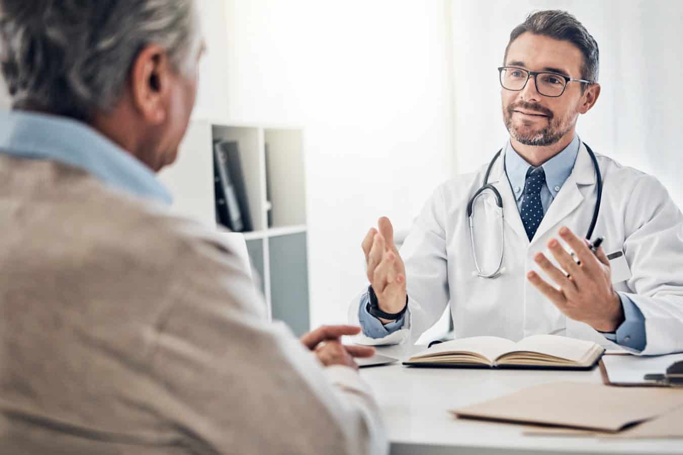 Lets talk about a treatment plan. a friendly doctor consulting with a mature patient in his office