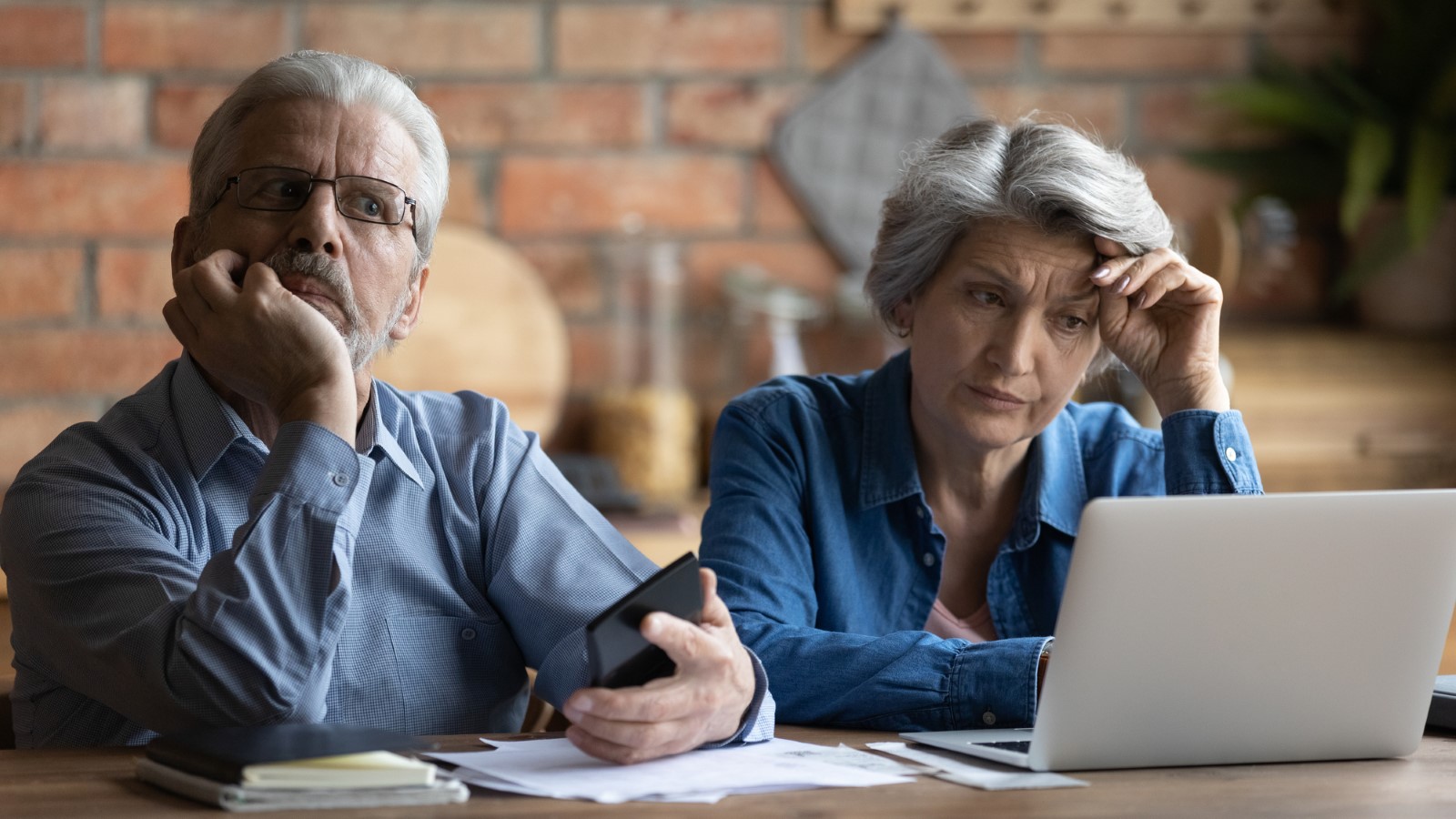 Unhappy older senior family couple thinking of financial problems