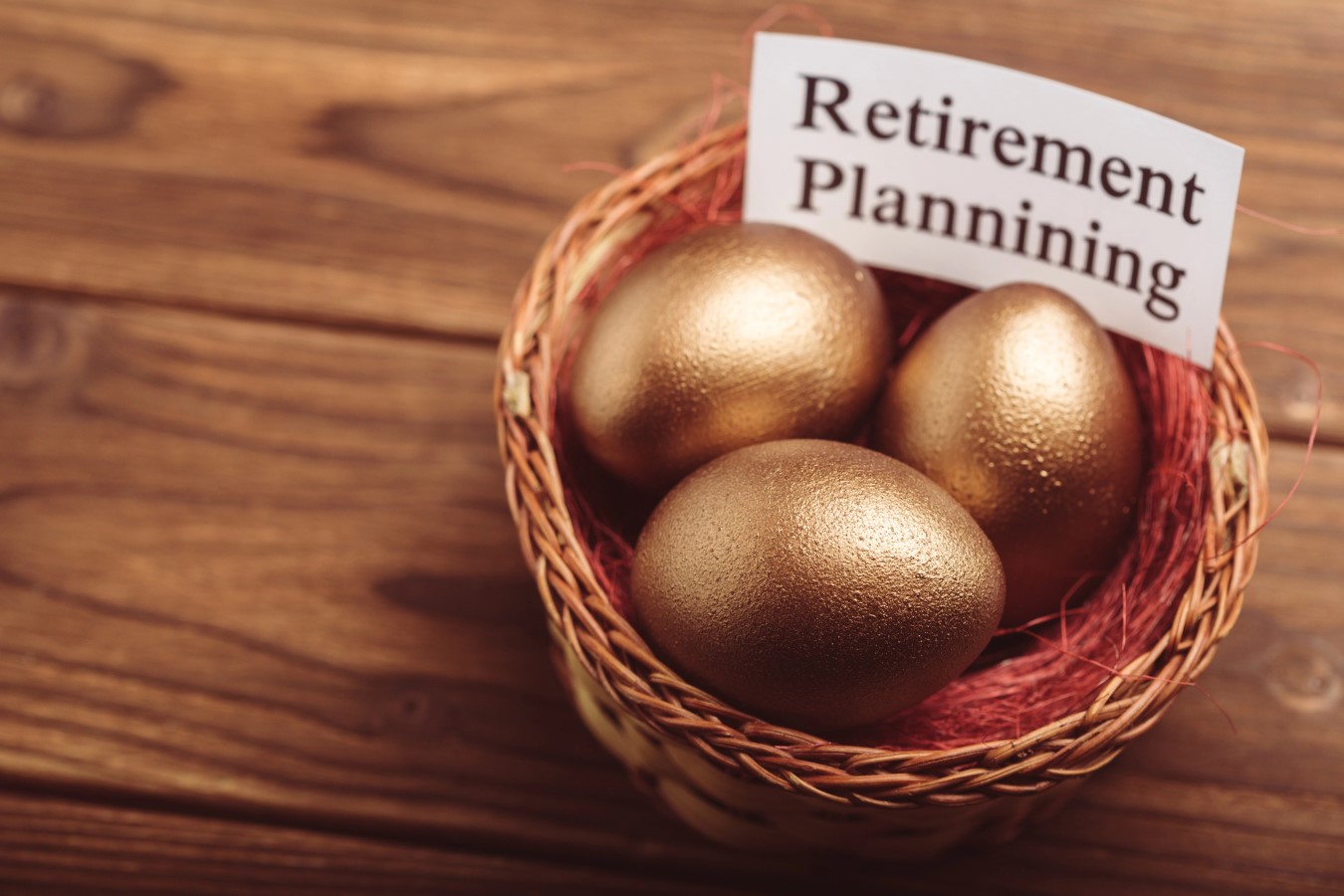 401k retirement planning Gold easter eggs on wooden table