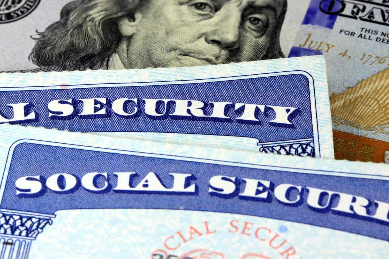 Social security card and US currency one hundred dollar bill