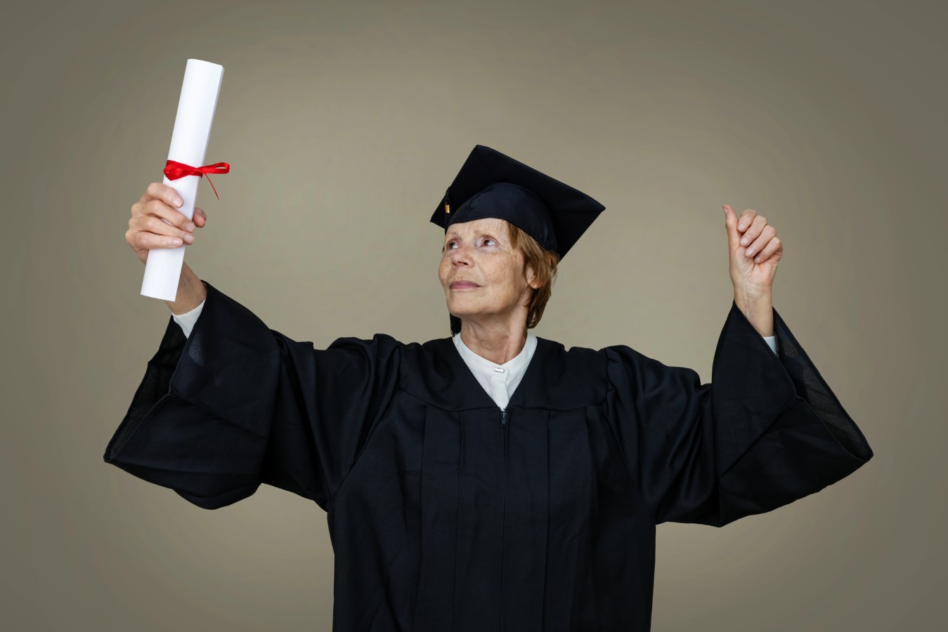 Trump Pauses Social Security Garnishments, Letting Student Loan Defaulters Off the Hook, For Now 1 Senior woman graduate in graduation gown and cap