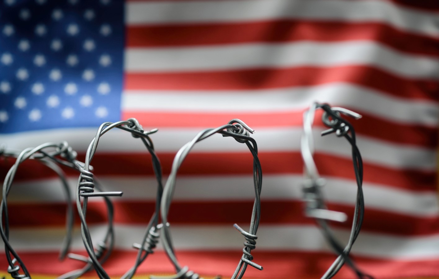 CBO Plan Would Strip Tax Credits from Anyone Without a Valid Work SSN; $28 Billion Savings 1 Barbed wire and United States of America flag