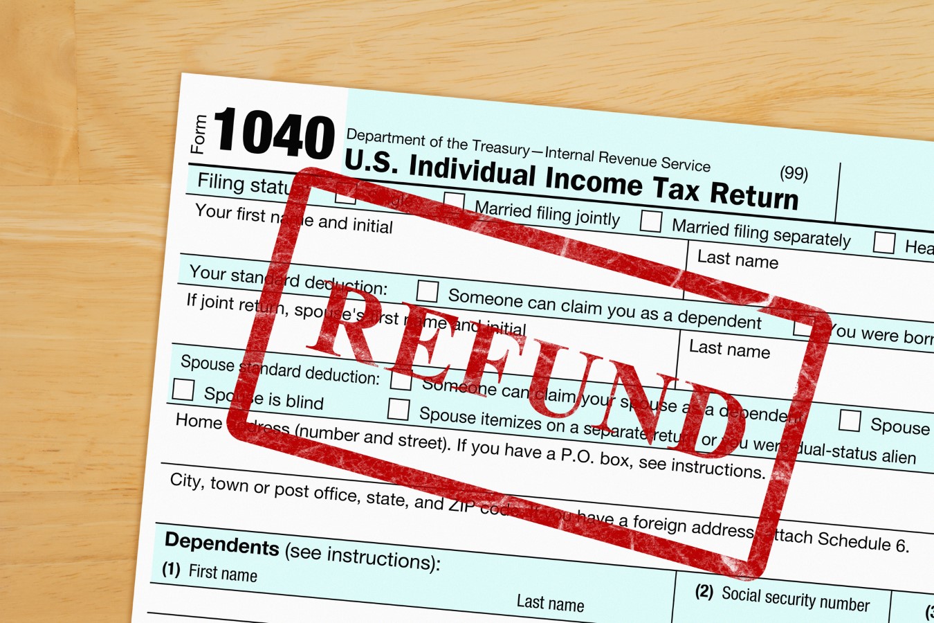 Trump Ends IRS Free Filing Program as Chief Declares: “I Don’t Care About Direct File” 11 Refund message with US federal 1040 tax return form on a wood desk