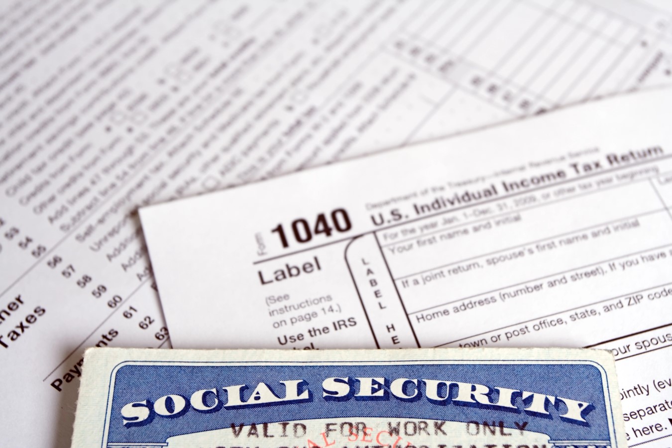 Depositphotos 2460202 L Social Security card and tax forms Photo by blasbike