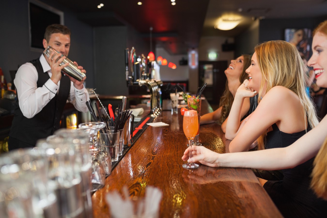 Bartender making cocktails for women