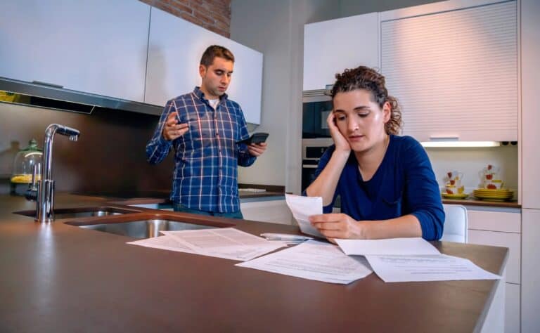 Worried young couple with debts reviewing their bills