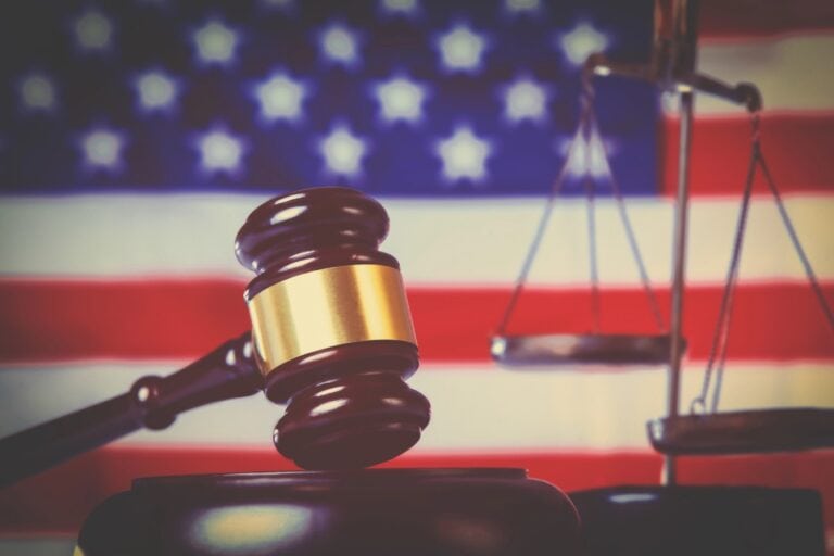 Judge gavel against United States national flag as symbol of Court cases