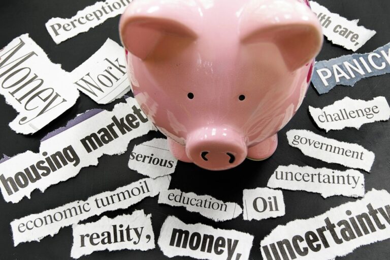 Torn newspaper headlines showing bad news with piggy bank