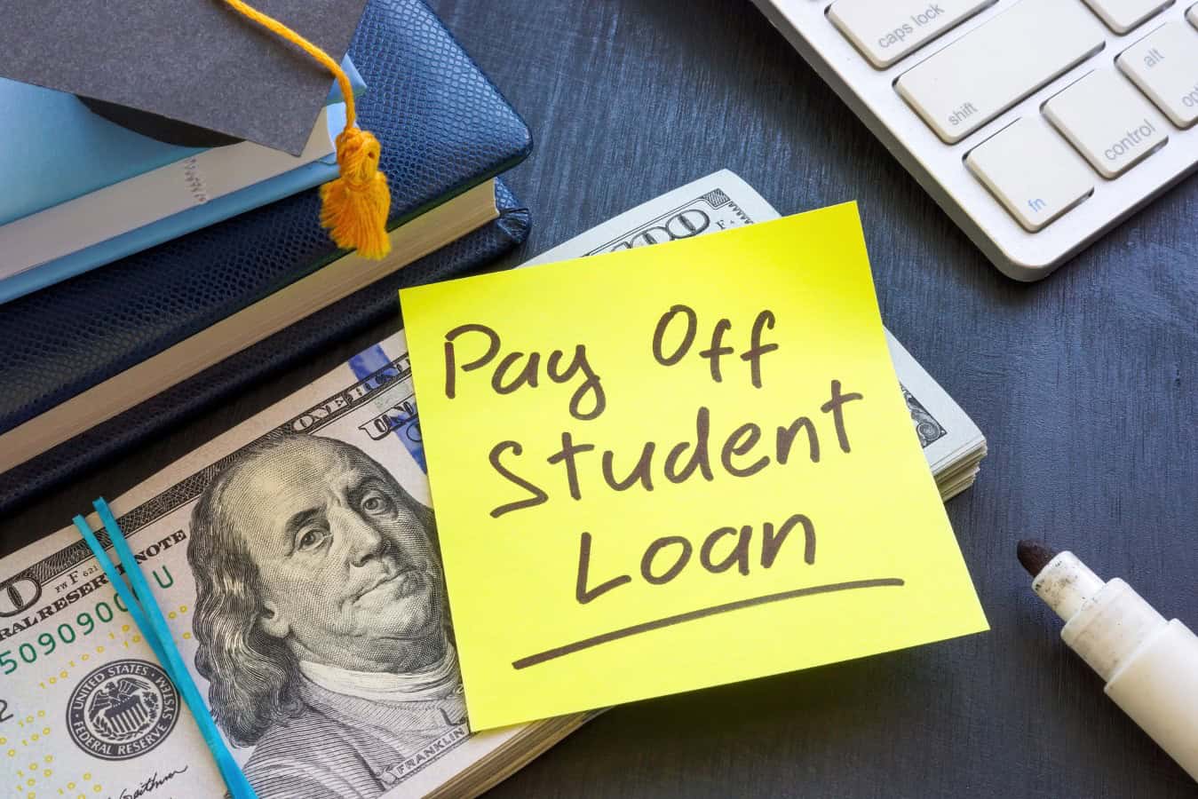 Bundle of money and inscription Pay off student loan