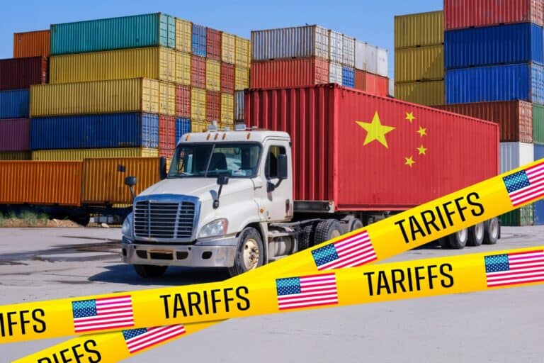A China-marked shipping container on a truck, blocked by US 'Tariffs' tape