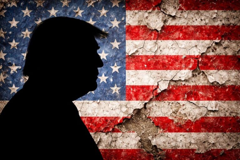 Silhouette of Donald Trump in profile set against a distressed American flag background