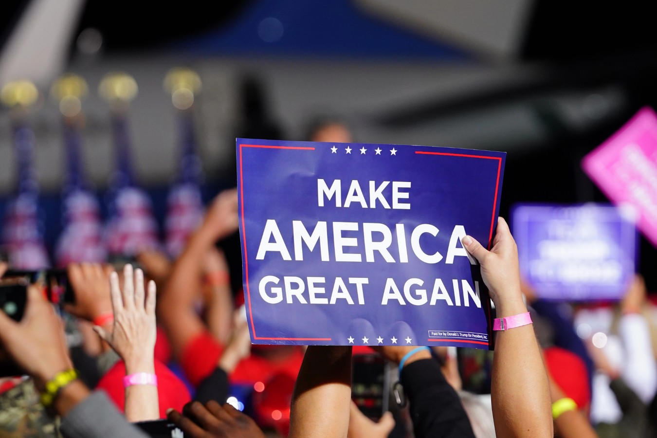 Donald trump supporters holding up signs make america great again